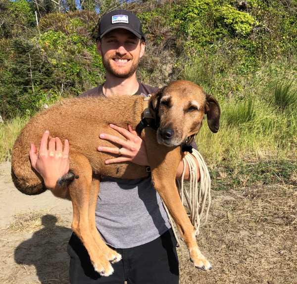 Zach carrying his dog Rooney